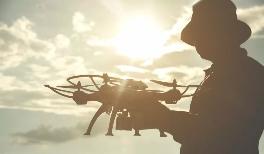 Homem operando drone. Imagem: canva
